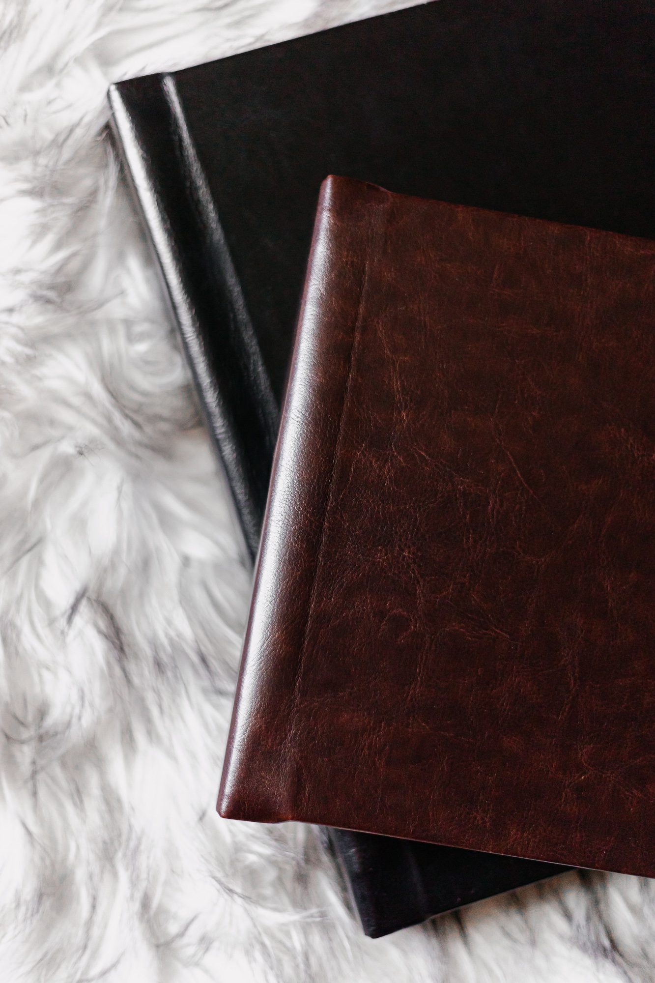 Photo of boudoir albums laying on rug