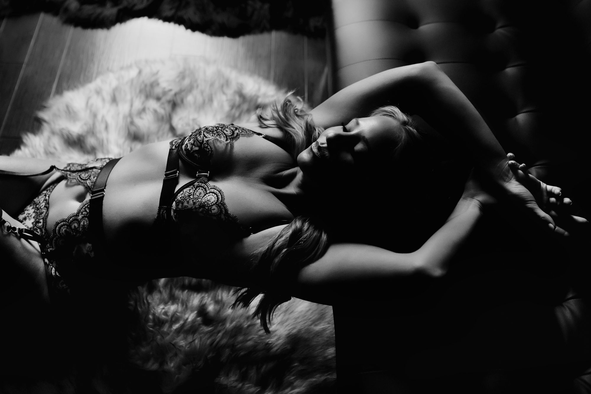 Denver boudoir client posing for dark and moody boudoir photos in lace lingerie outfit