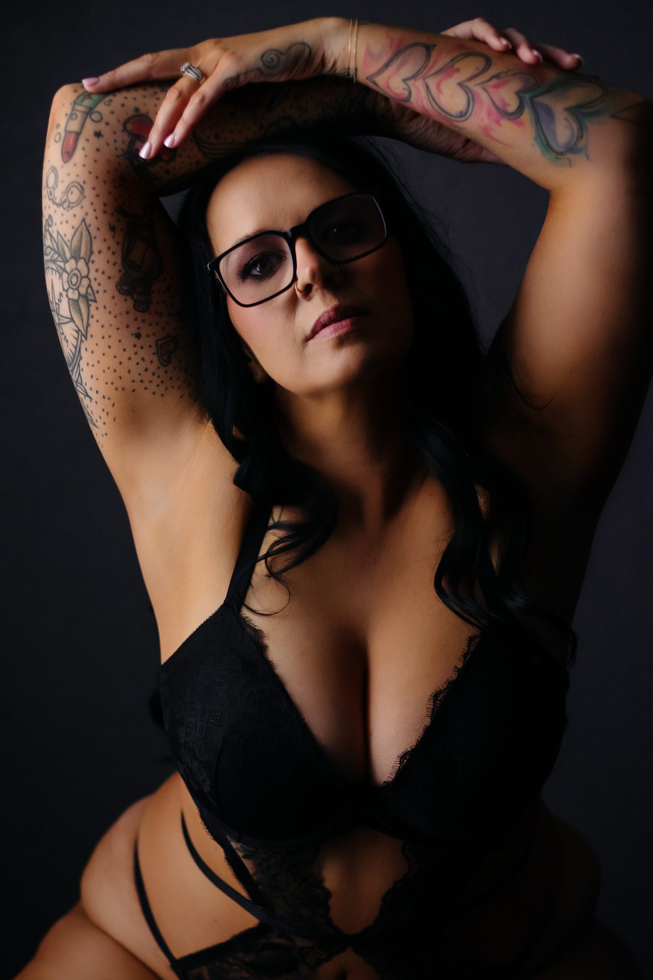 Real life boudoir client wearing glasses during boudoir photo shoot