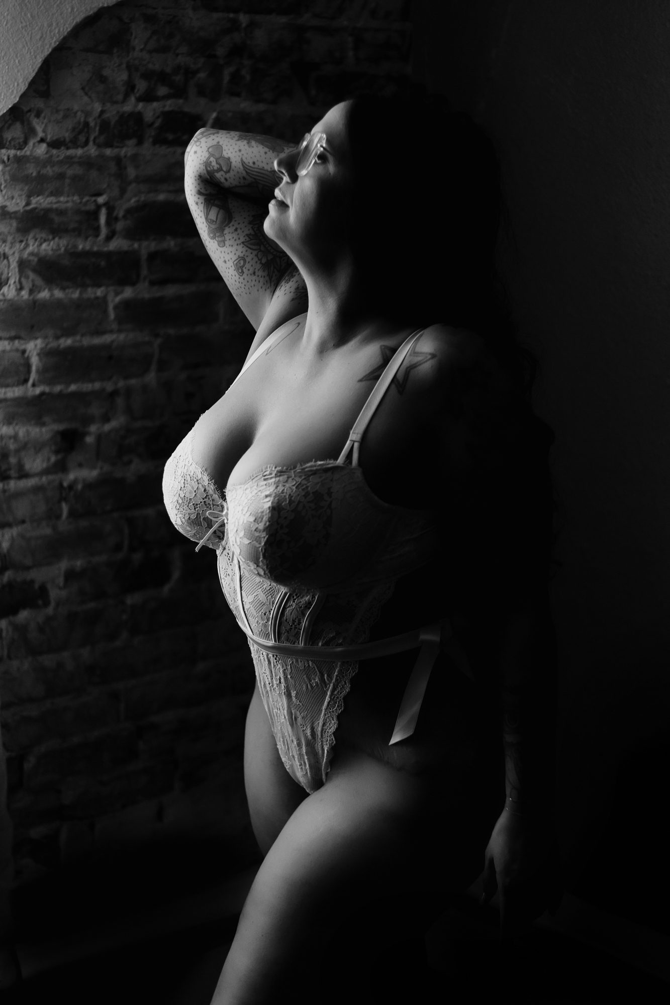 Boudoir client wearing glasses during boudoir shoot